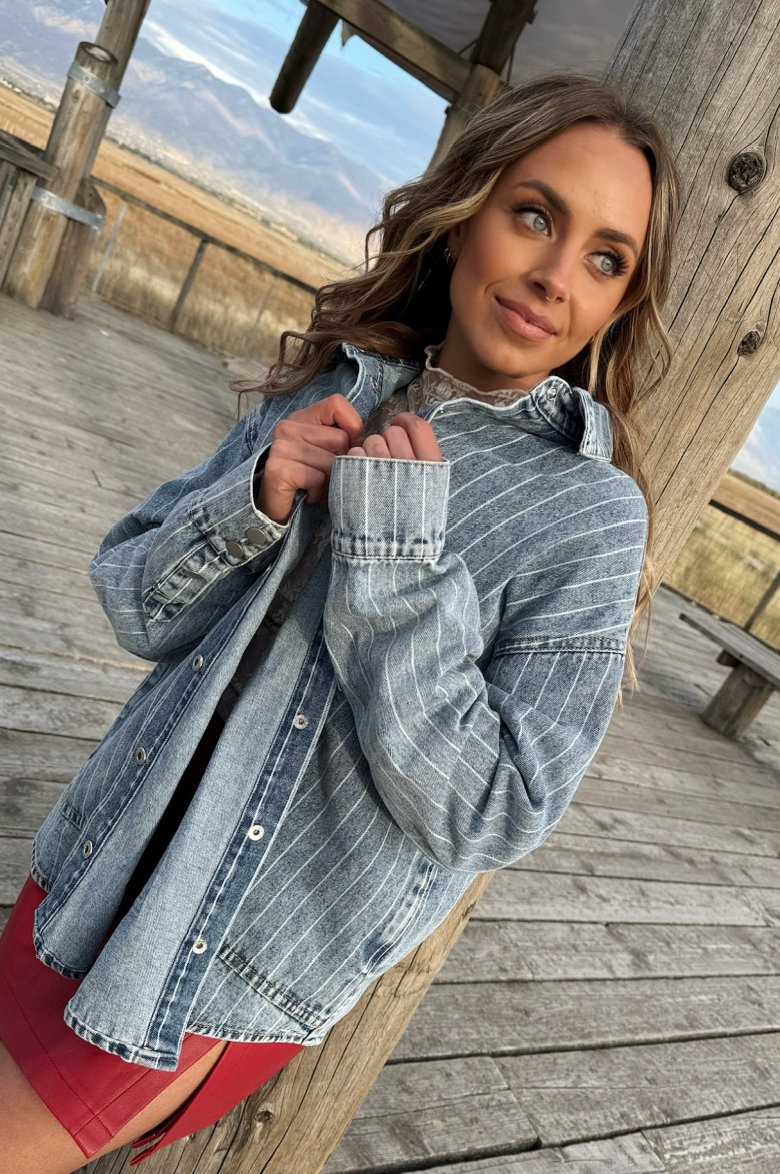 Denim shacket with pockets and snap button closure.