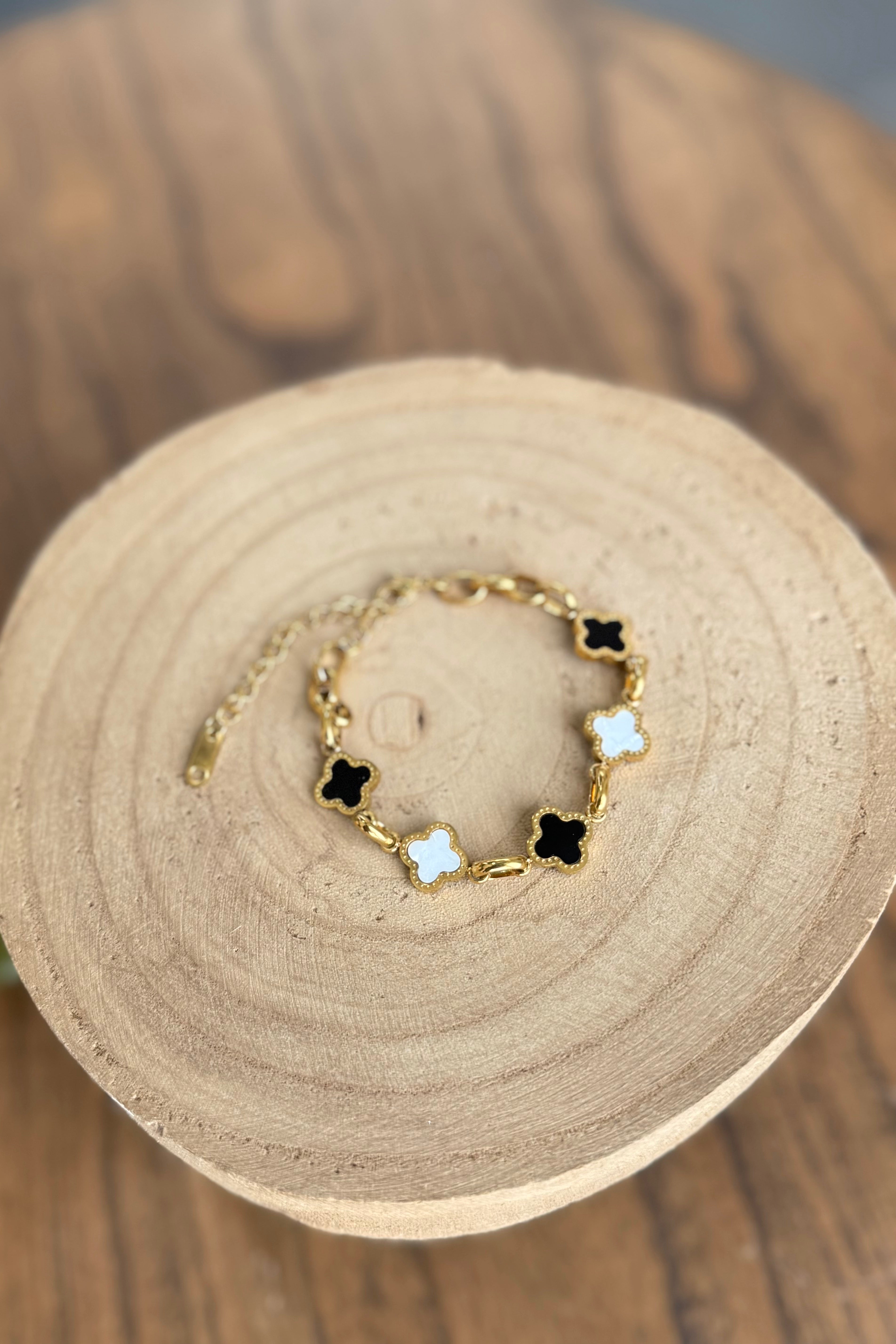 white and black clover necklace with gold hardware