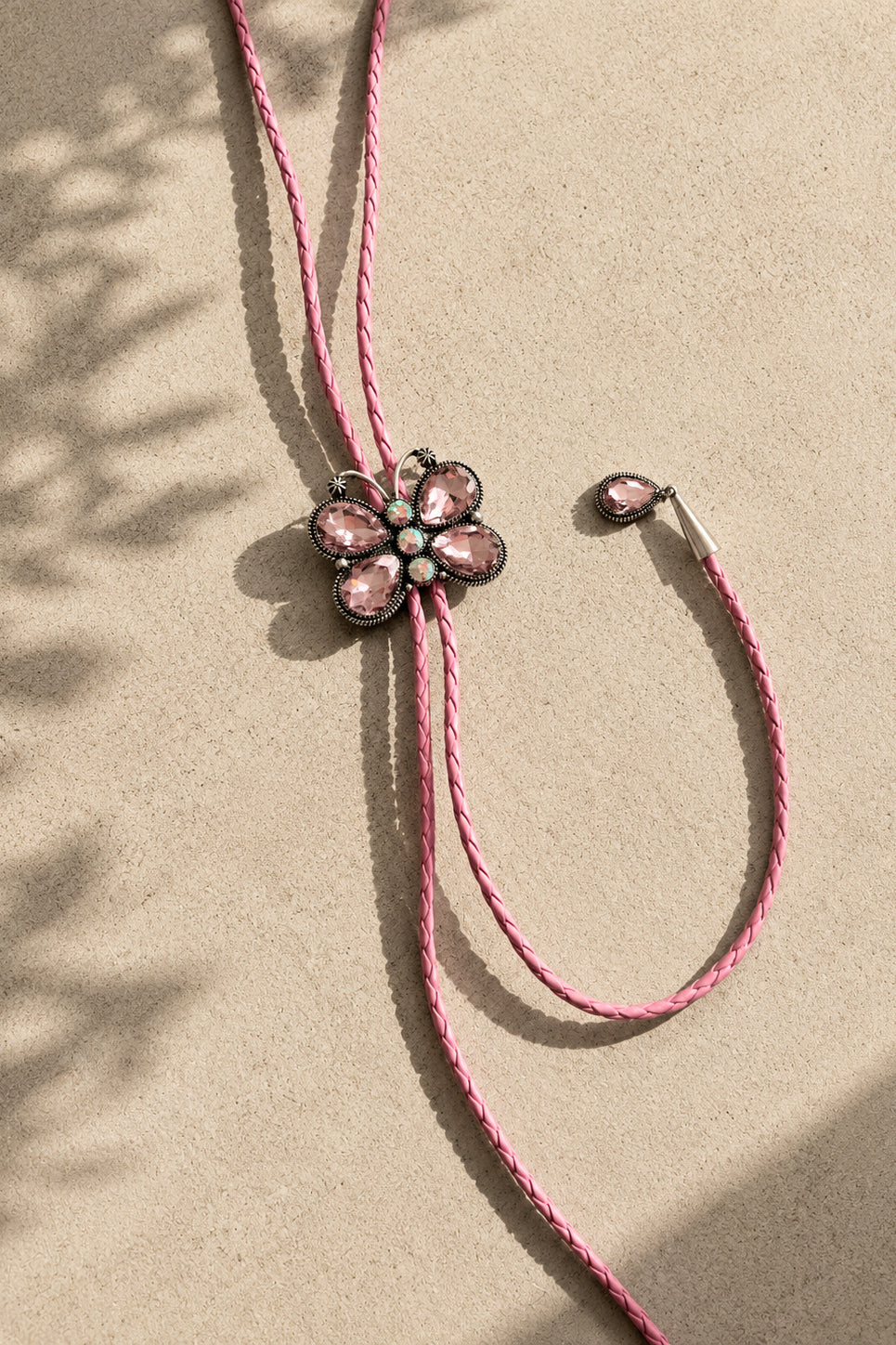 Pink western bolo tie necklace with sparkling crystal butterfly centerpiece and silver-tone tips
