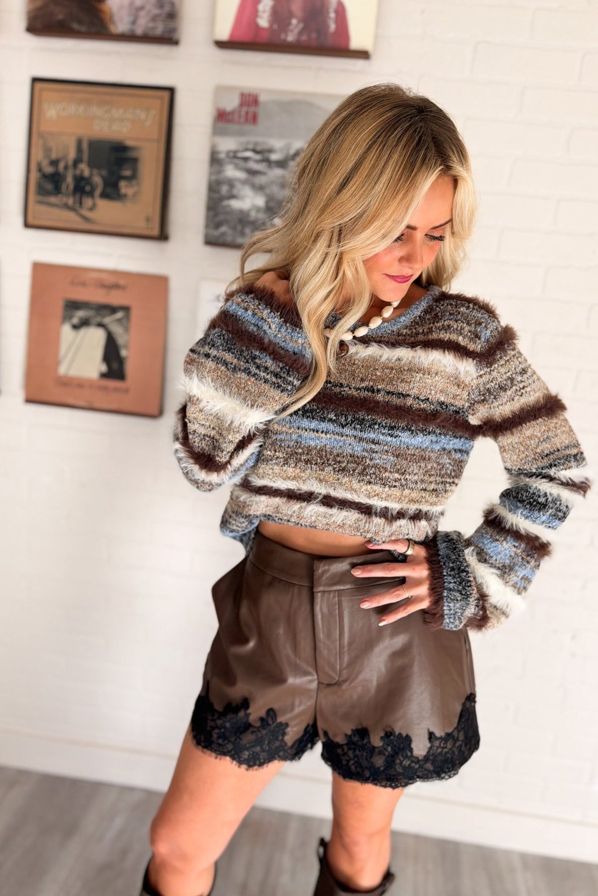 Women’s blue multi-texture knit sweater featuring mixed marled yarn, fuzzy contrast eyelash stripe detailing, a crew neckline, relaxed silhouette, and long bell sleeves.
