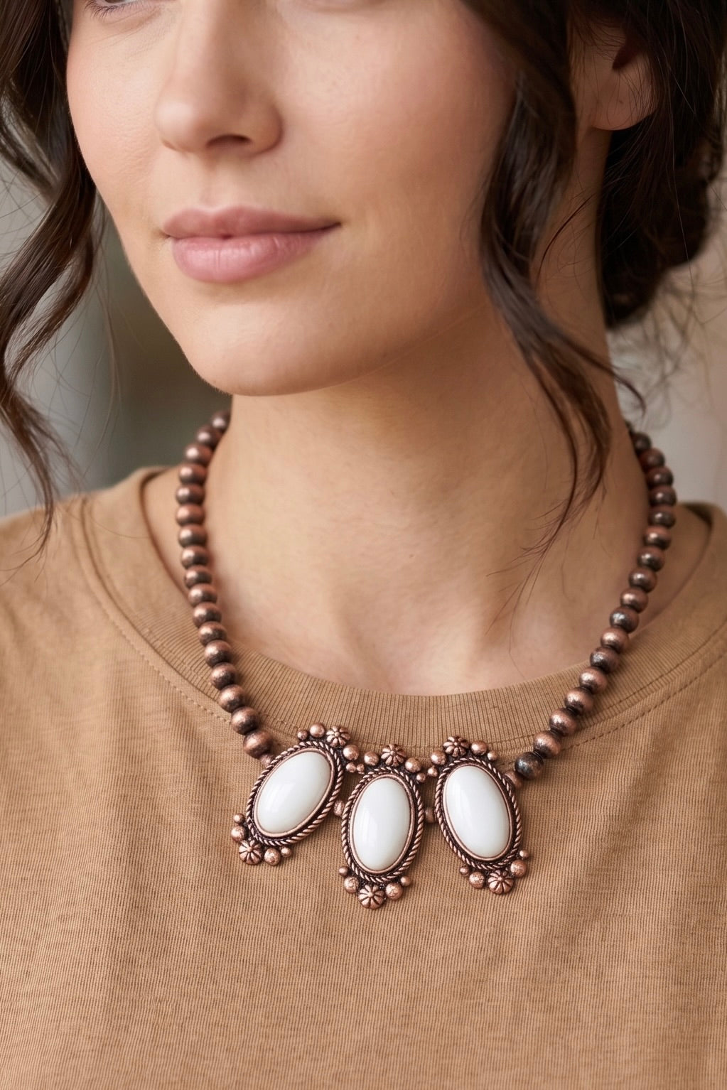 Handmade antique copper-tone Western bead necklace with three oval natural white turquoise stone pendants and floral detailing.