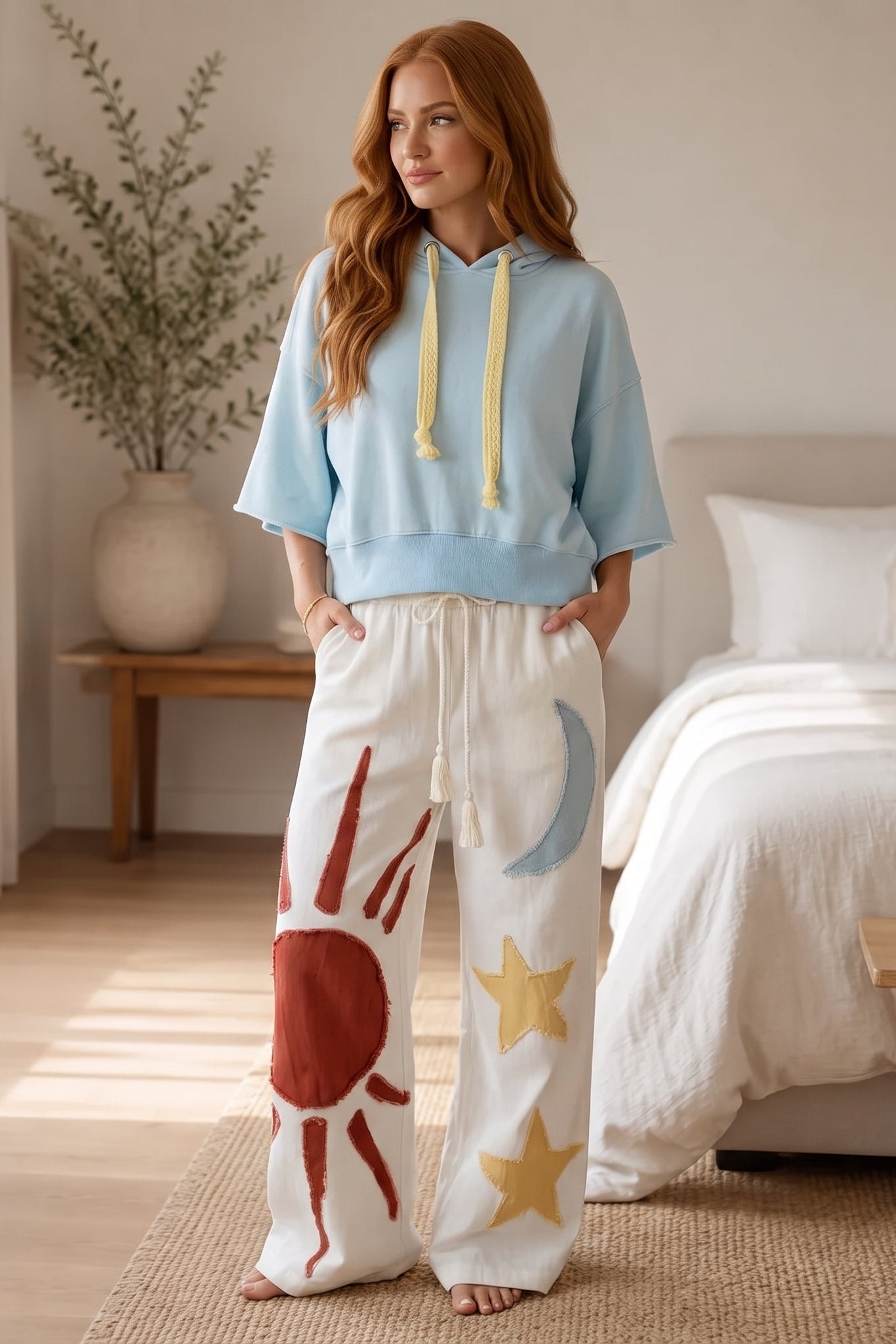Light blue short sleeve hoodie with a relaxed fit, raw edge sleeves, and contrast yellow knitted drawstrings.
