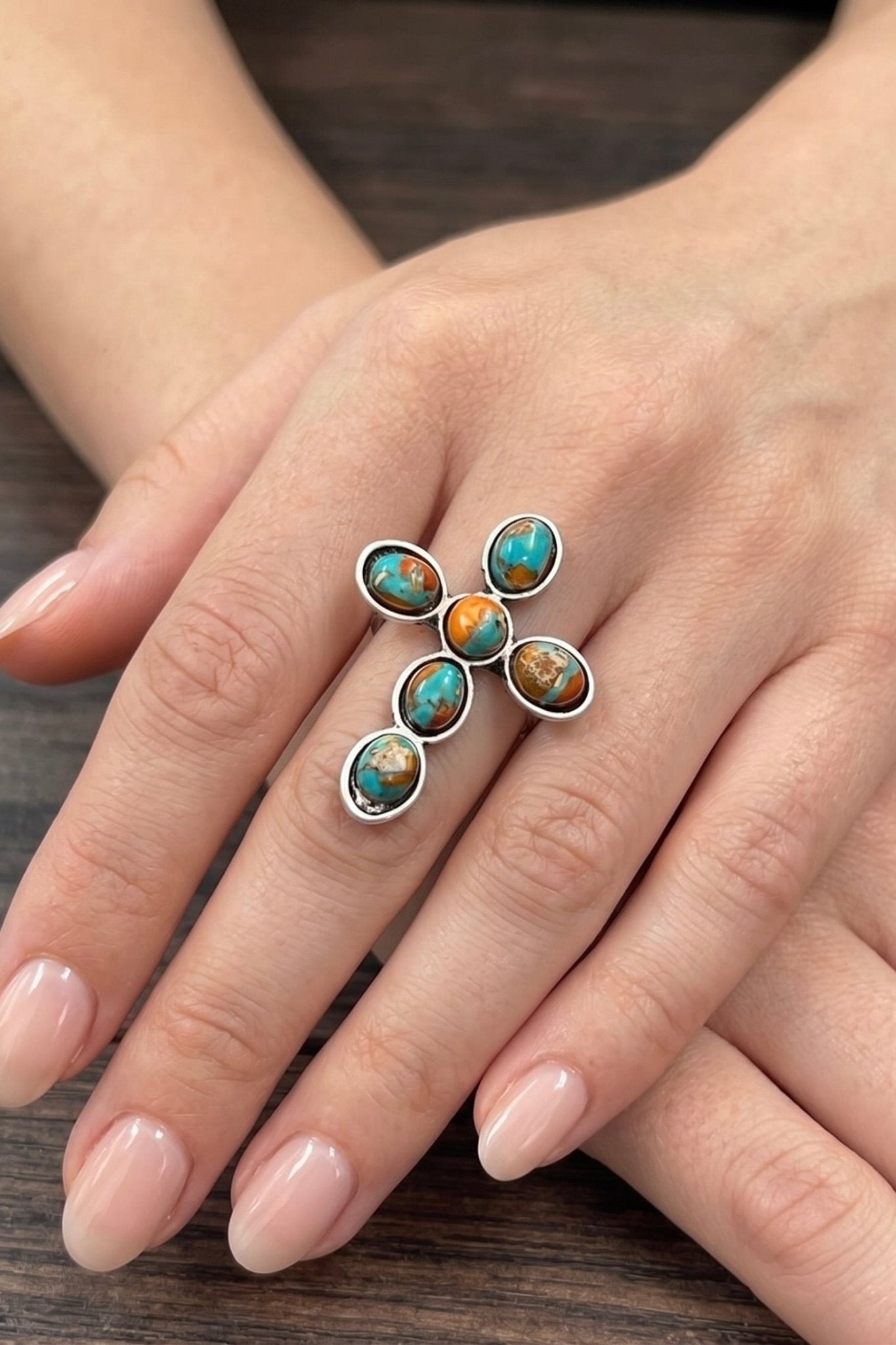 Natural gemstone cross statement ring with turquoise and earthy-toned stones, antique silver finish, and adjustable dual brass band.