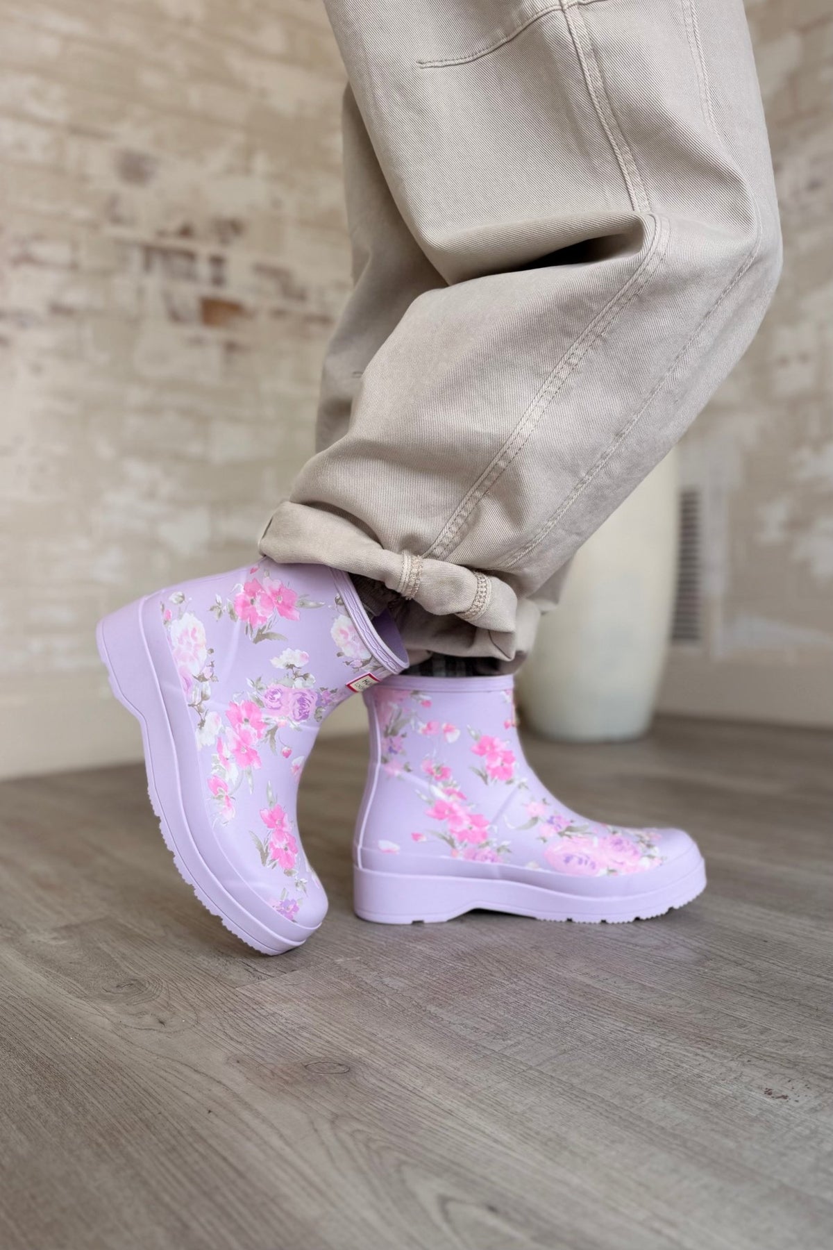 Hunter x LoveShackFancy women’s PLAY™ ankle rain boots in the purple Happy Thoughts floral print, featuring waterproof natural rubber construction, platform soles, and back pull tabs.