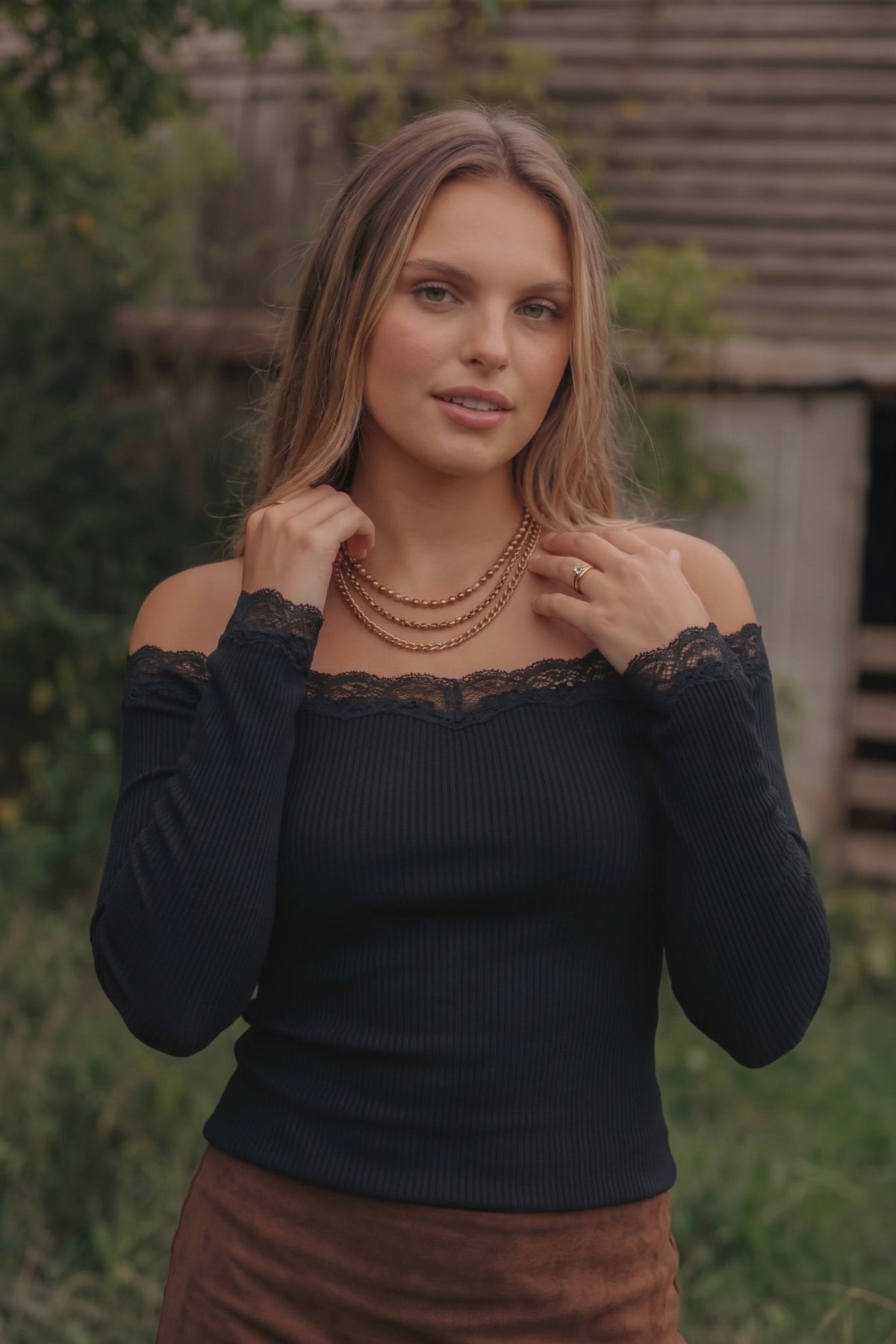 long sleeve fitted top with an off-the-shoulder neckline and delicate lace trim.