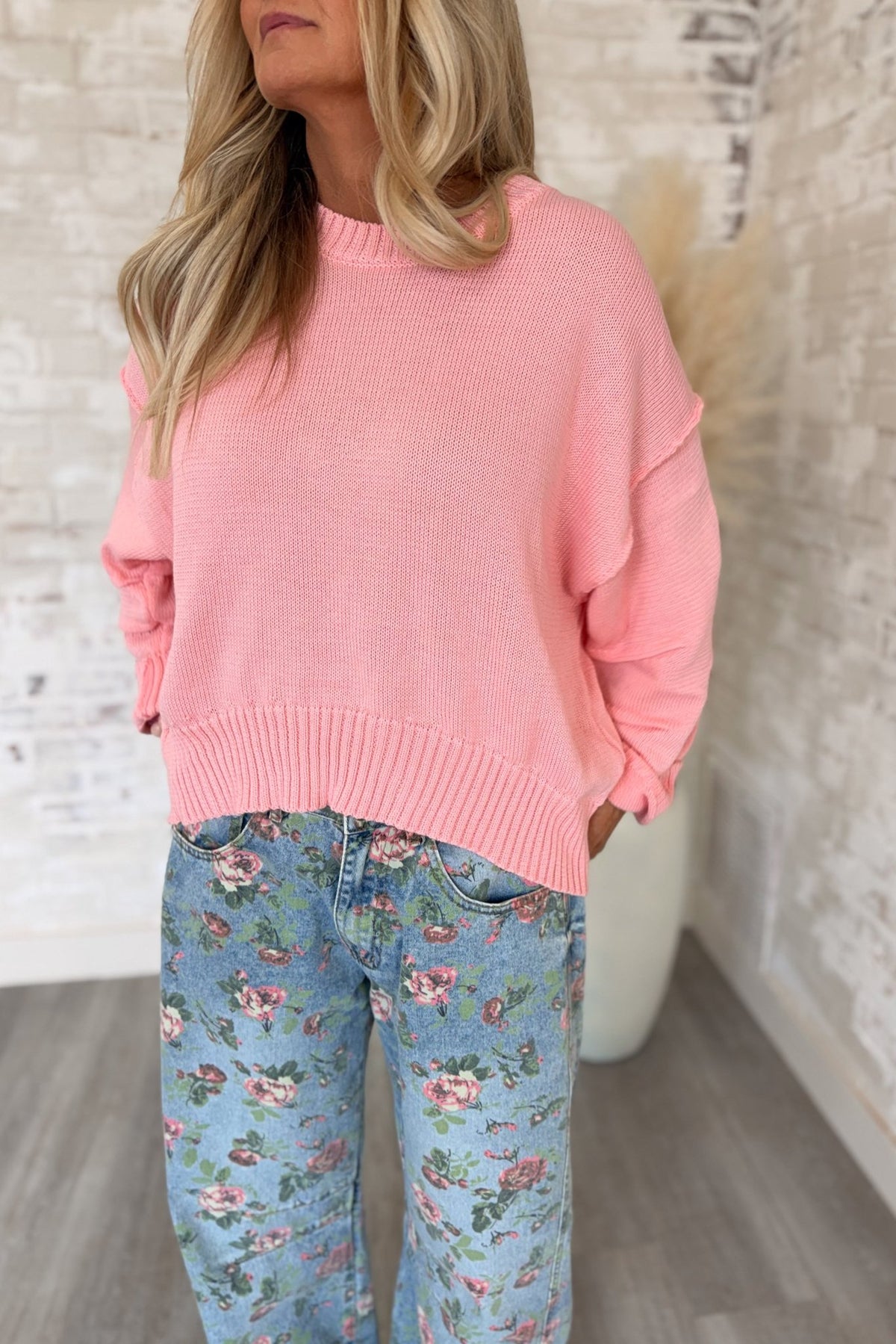 Women’s bubblegum pink knit sweater featuring a relaxed oversized fit, classic crew neckline, dropped shoulders, long sleeves, ribbed cuffs, and a wide ribbed hem with a slightly cropped silhouette for an easy everyday layering style.
