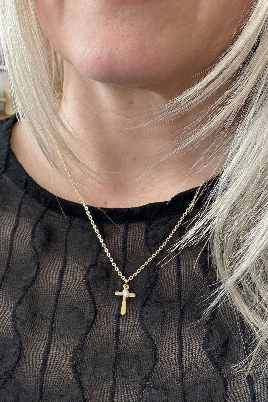 Small gold cross with a pearl charm