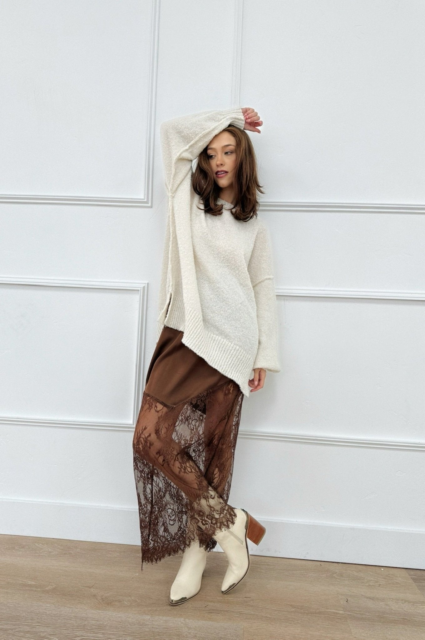 Brown satin midi skirt with sheer lace panels at the hem