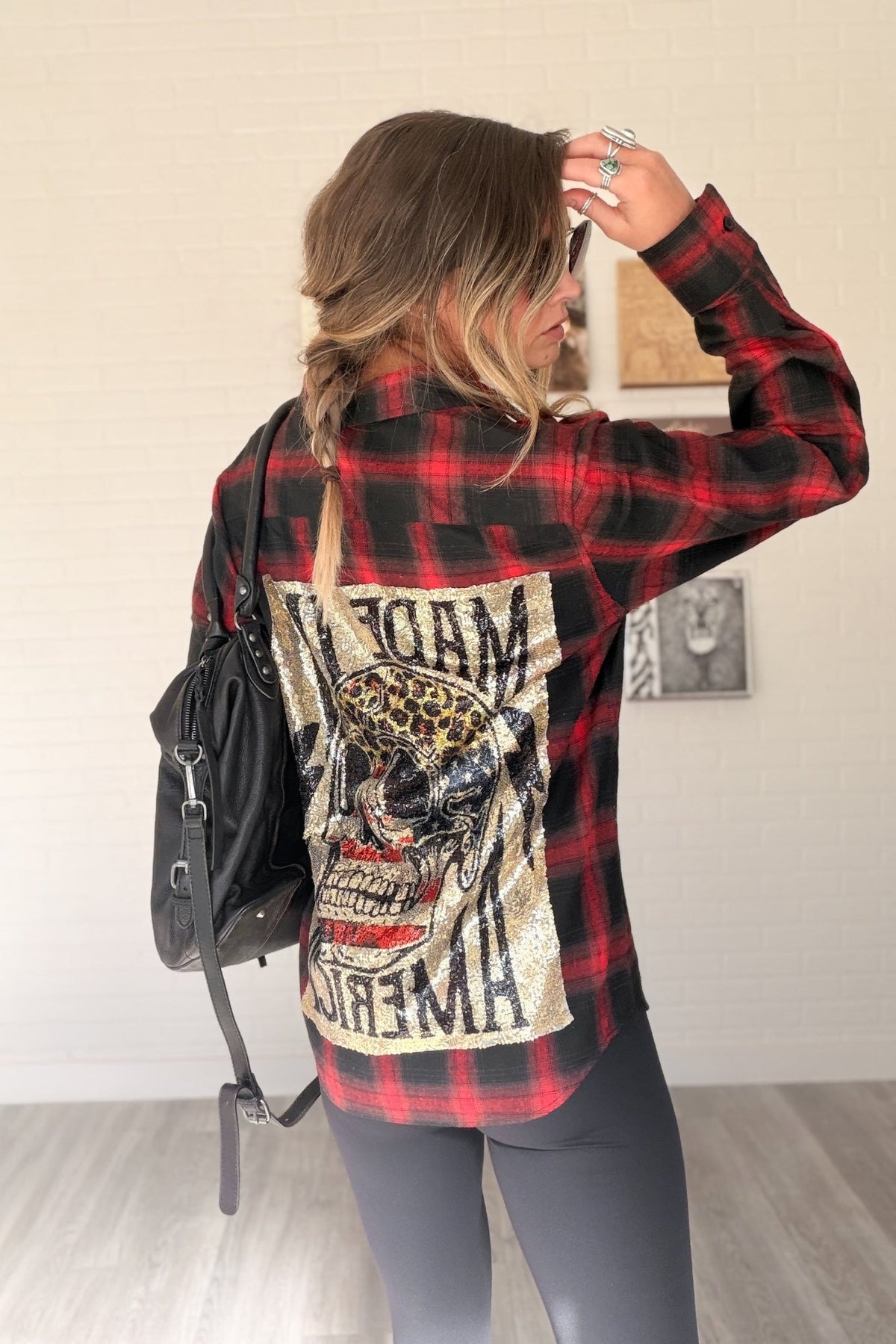 Women’s red, black and cream plaid flannel button-down shirt featuring a relaxed oversized fit, collared neckline, long sleeves, button front closure and dual chest flap pockets. Classic tartan plaid shirt styled as an easy layering piece for casual, grunge-inspired and fall outfits.