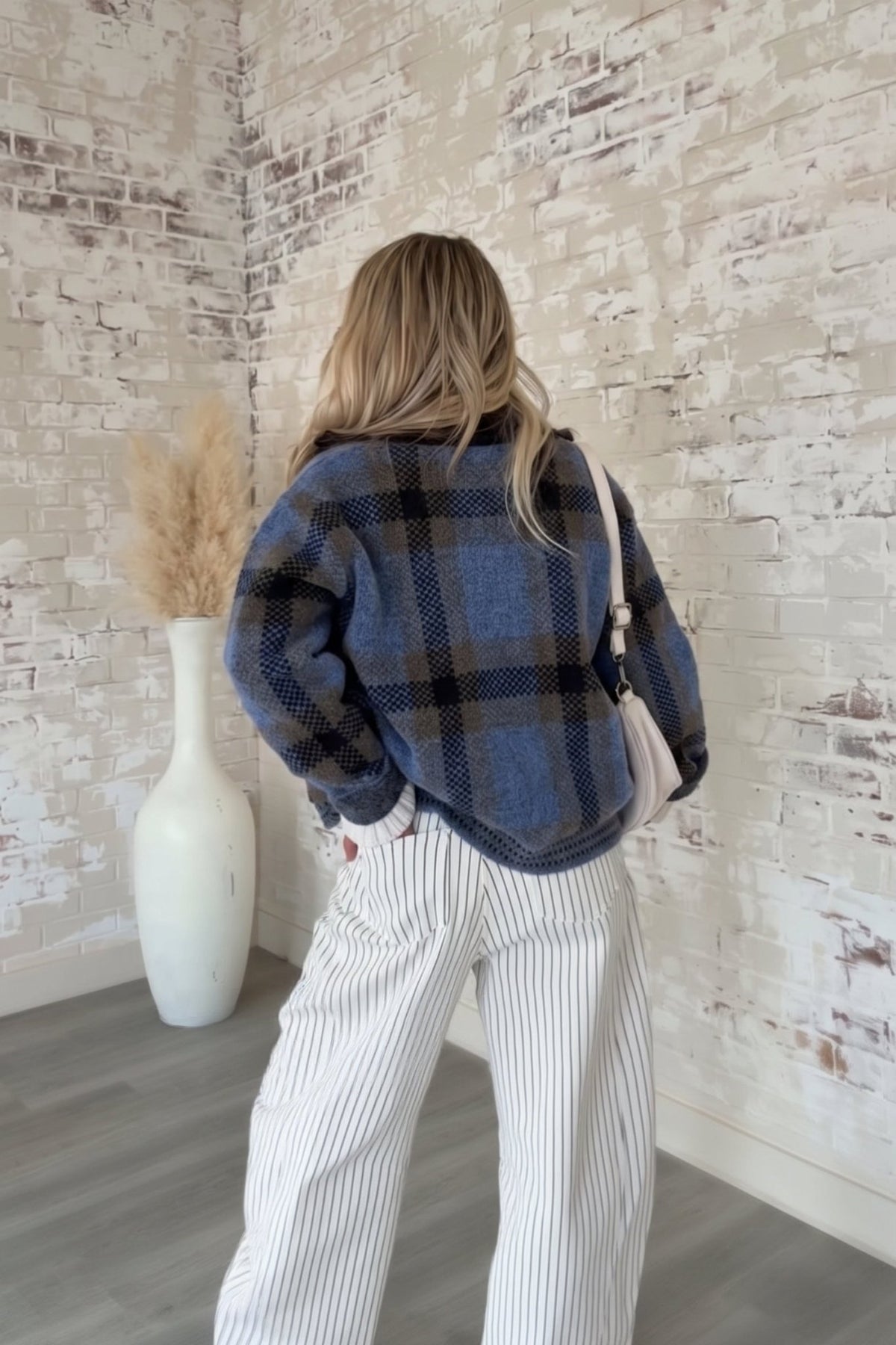 Women's dusty blue, charcoal gray, and brown plaid knit sweater jacket featuring a soft, textured brushed knit fabric, oversized buffalo check-inspired plaid pattern, relaxed boxy silhouette, classic fold-over collar, full front zipper closure, dropped shoulders, and long sleeves. This cozy, hip-length zip-up cardigan jacket features contrasting textured knit details along the hem and cuffs, combining vintage-inspired plaid styling with modern casual outerwear. Perfect for fall layering, winter outfits, coz