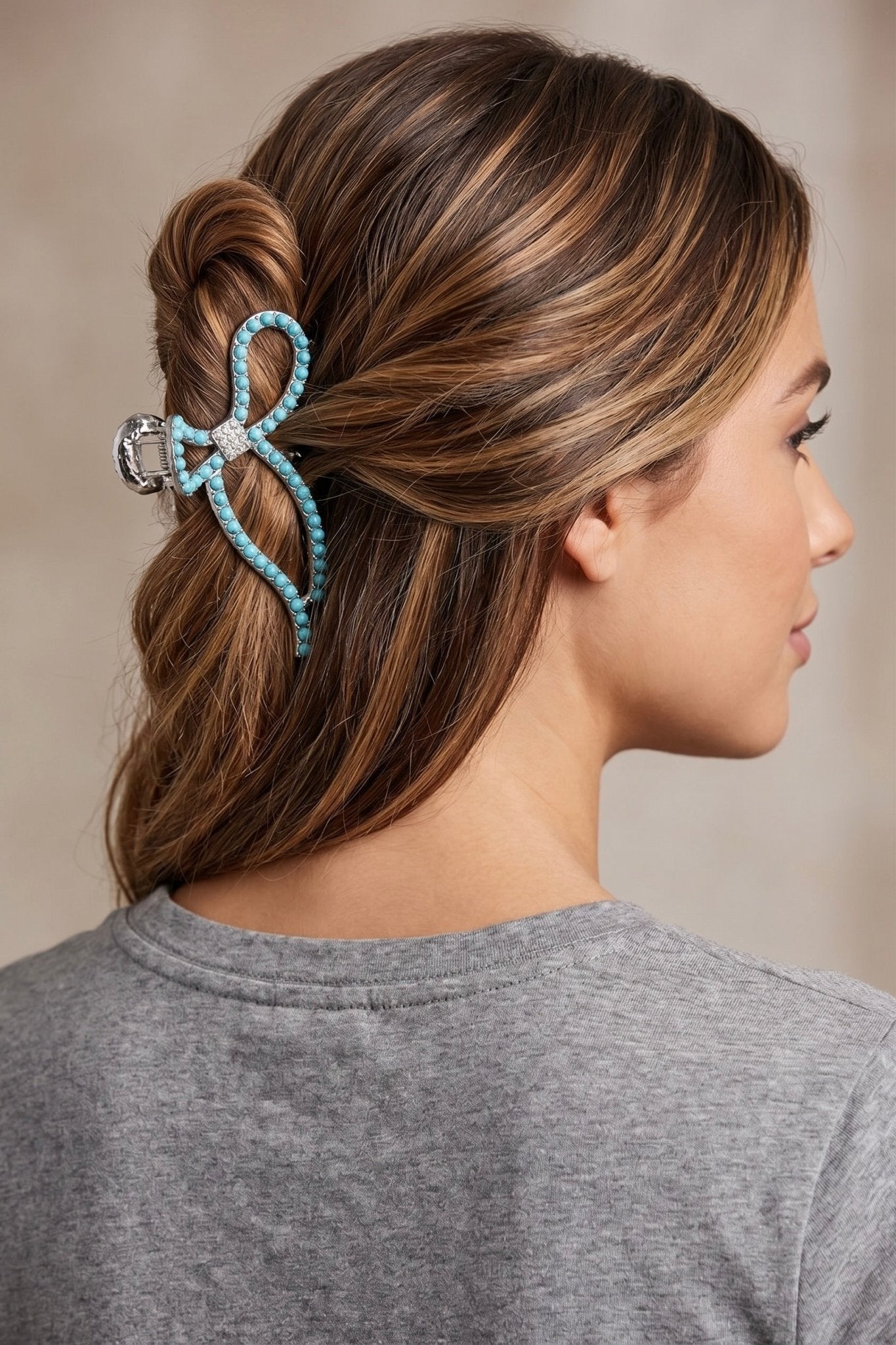 Western bow hair claw clip with turquoise-inspired bead detailing, crystal accents, and an antique silver finish designed for secure all-day hold.