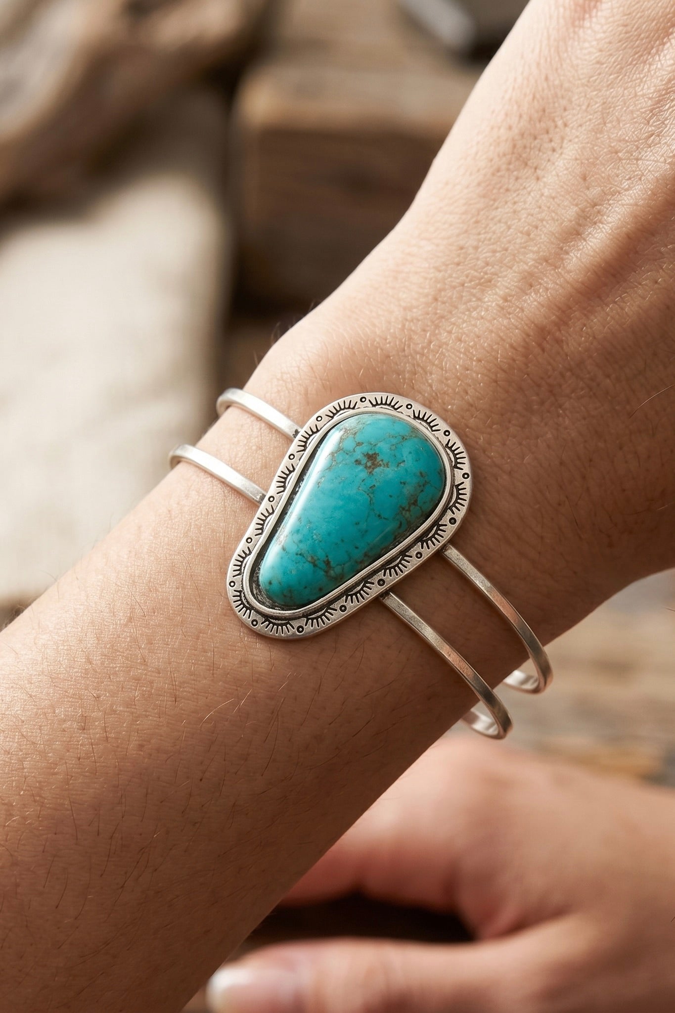 Navajo-inspired turquoise cuff bracelet featuring a natural turquoise stone set in an engraved antique silver setting with a brass split shank design, perfect for western, boho, rodeo, and country concert outfits.