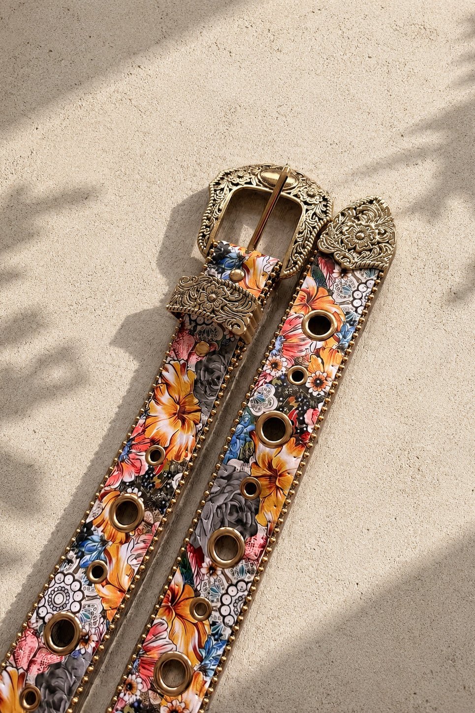 Wide multicolor floral Western PU belt with ornate antique-style engraved buckle, decorative metal hardware and studded edging.