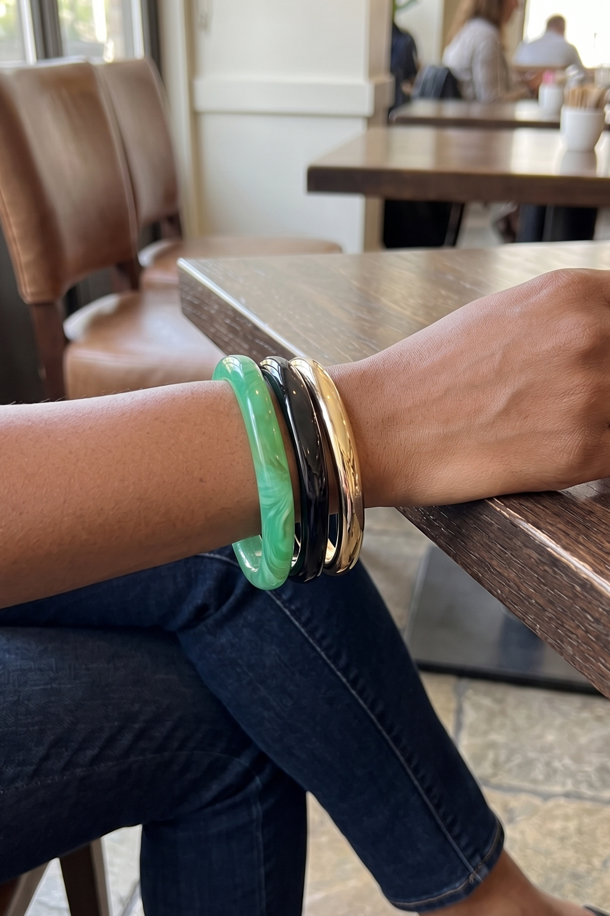 fun bracelet stack with a green, gold, and black bangle