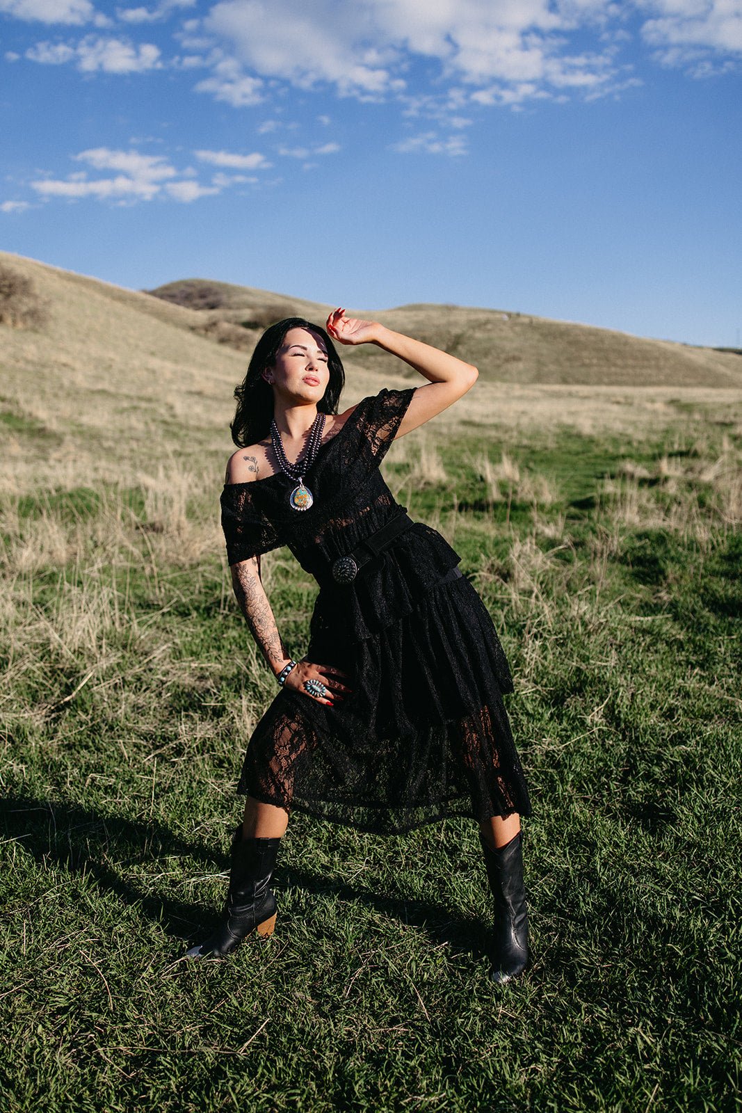 Western lace dress, country concert outfit, off-the-shoulder black dress, tiered lace midi, rodeo fashion, boho western style, moody romantic dress.