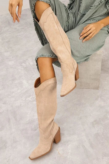 High Stakes beige genuine suede knee high Western boots with almond toes, Western detailing and stacked block heels.