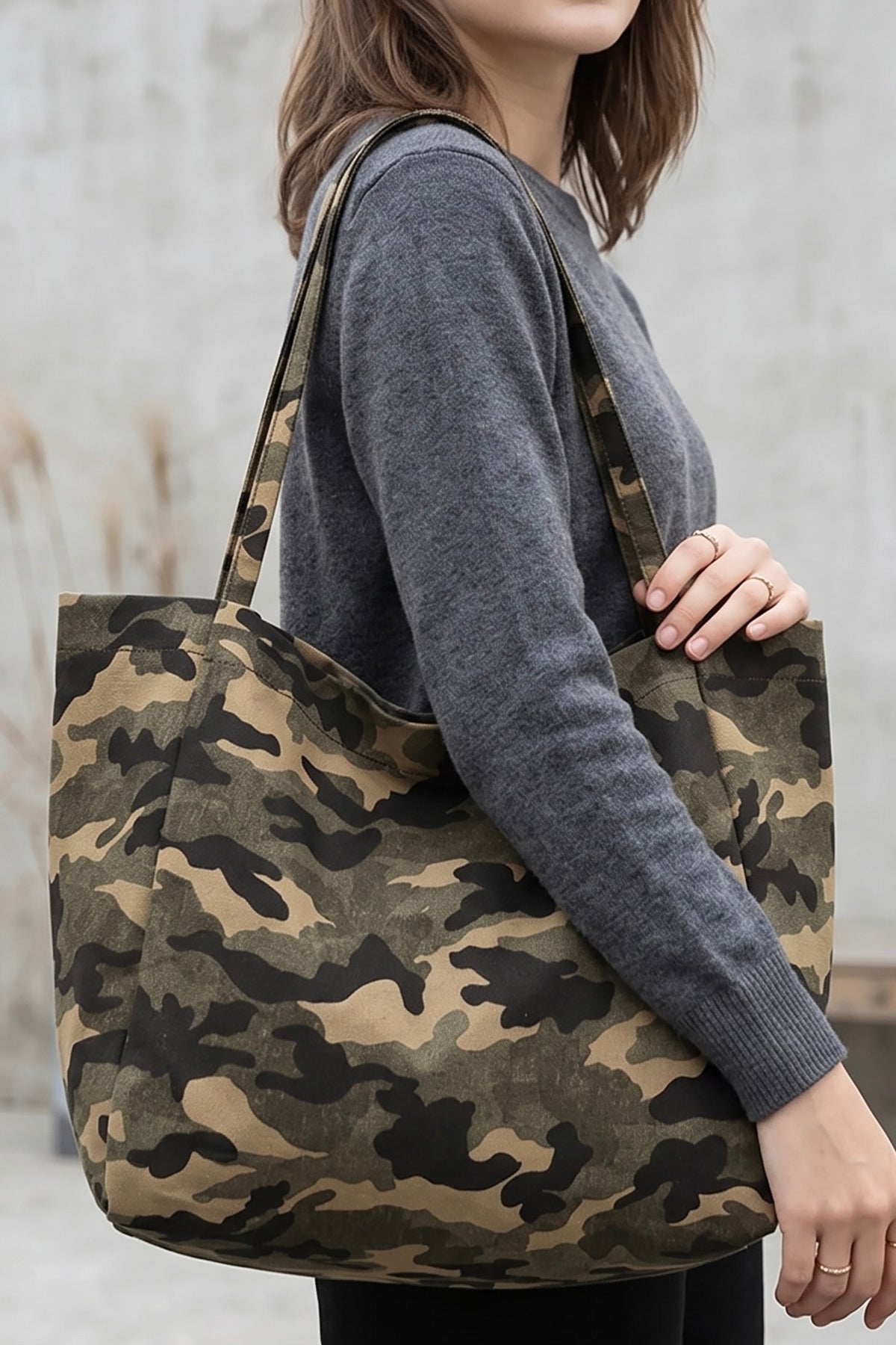 Casual camouflage canvas shoulder tote bag with long straps and oversized slouchy silhouette.
