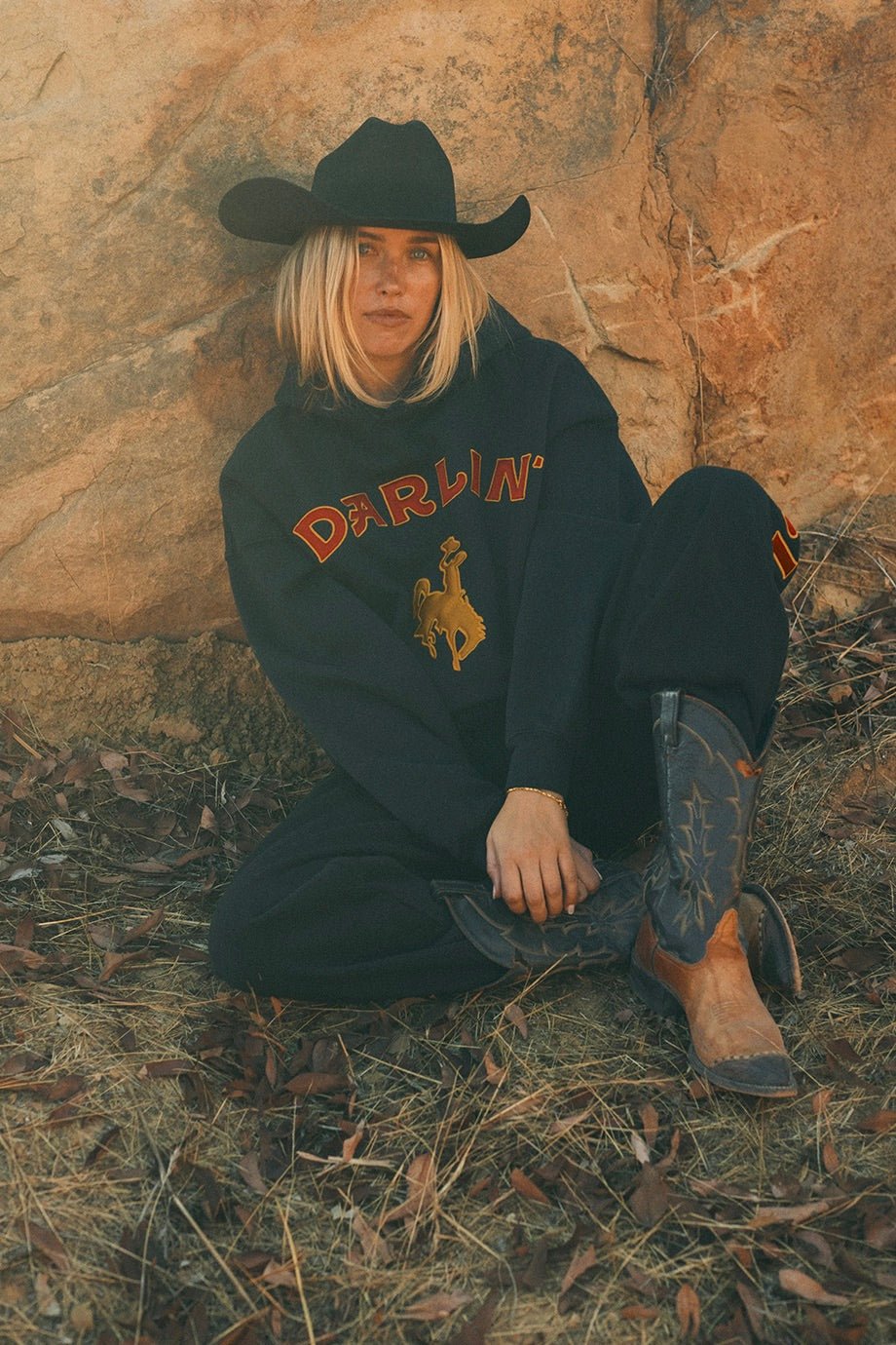 Darlin’ Rider Oversized Hoodie in black featuring bold DARLIN’ lettering and a yellow bucking horse graphic
