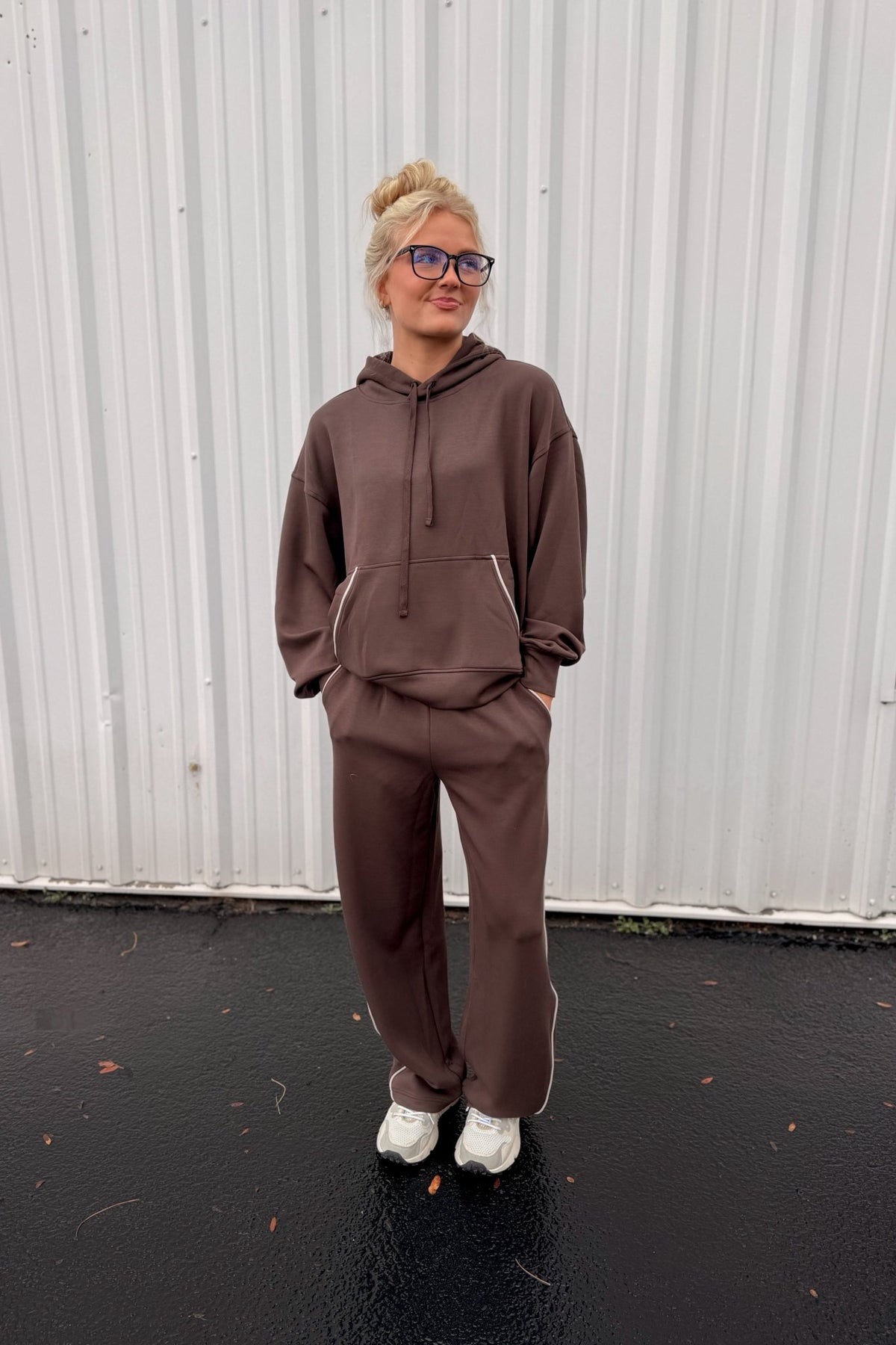 Women’s chocolate brown wide-leg sweatpants featuring a relaxed straight-leg silhouette, comfortable pull-on waistband, side pockets, and contrast ivory piping down the outer legs. Cozy lounge pants designed to coordinate with the matching chocolate brown hoodie, sold separately.