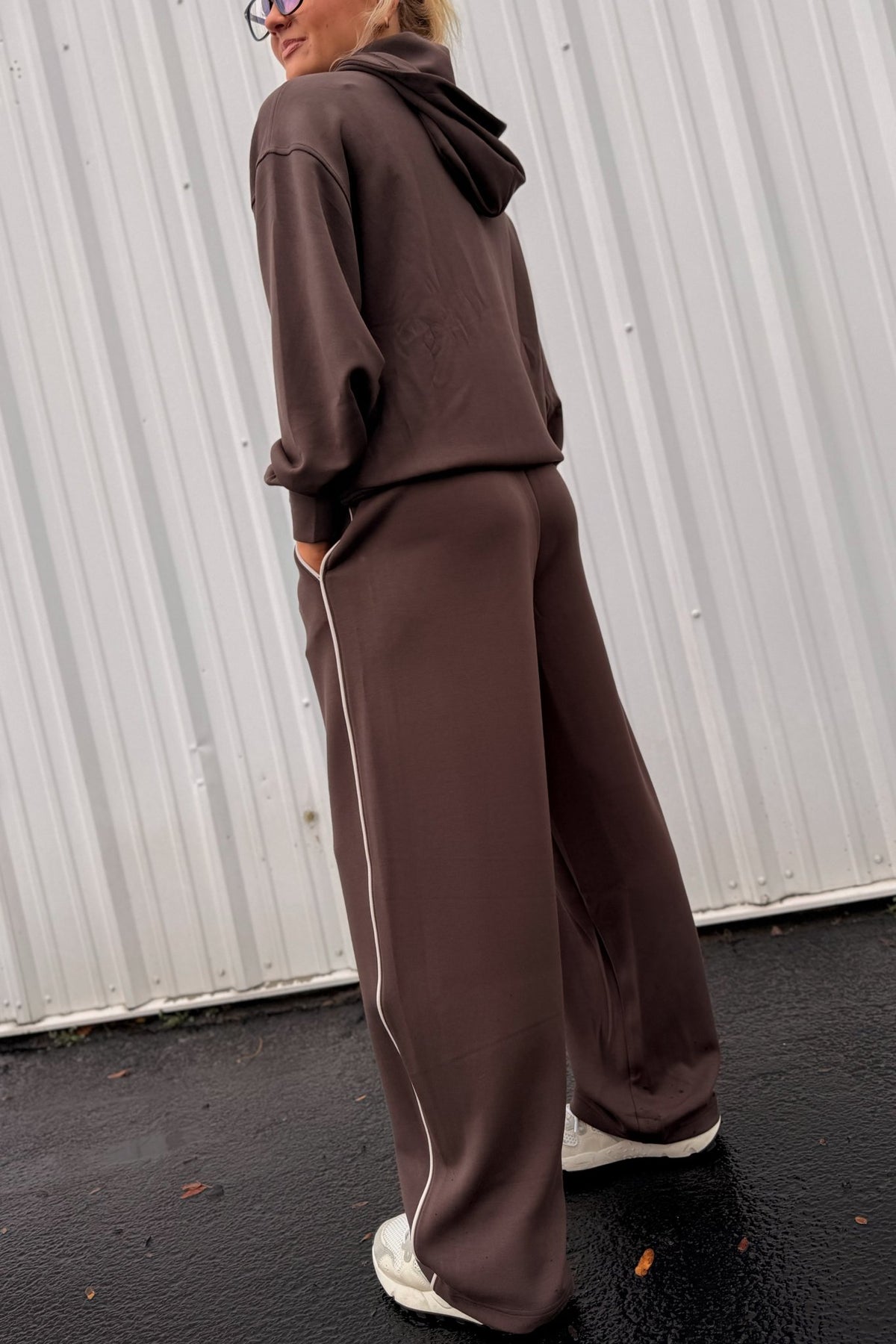 Women’s chocolate brown wide-leg sweatpants featuring a relaxed straight-leg silhouette, comfortable pull-on waistband, side pockets, and contrast ivory piping down the outer legs. Cozy lounge pants designed to coordinate with the matching chocolate brown hoodie, sold separately.