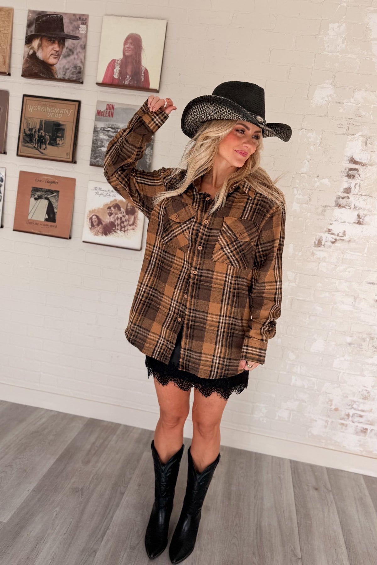 Women’s red, black and cream plaid flannel button-down shirt featuring a relaxed oversized fit, collared neckline, long sleeves, button front closure and dual chest flap pockets. Classic tartan plaid shirt styled as an easy layering piece for casual, grunge-inspired and fall outfits.