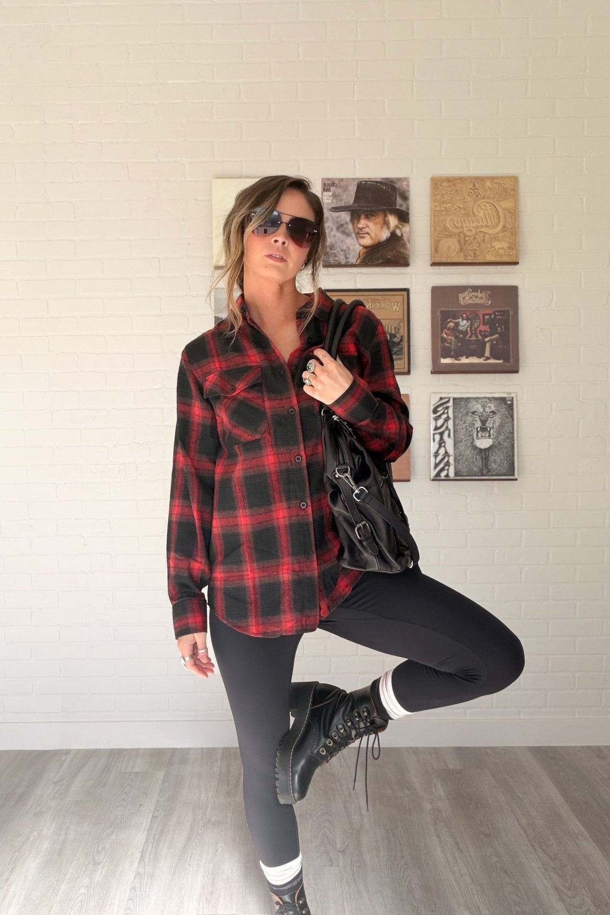 Women’s red, black and cream plaid flannel button-down shirt featuring a relaxed oversized fit, collared neckline, long sleeves, button front closure and dual chest flap pockets. Classic tartan plaid shirt styled as an easy layering piece for casual, grunge-inspired and fall outfits.