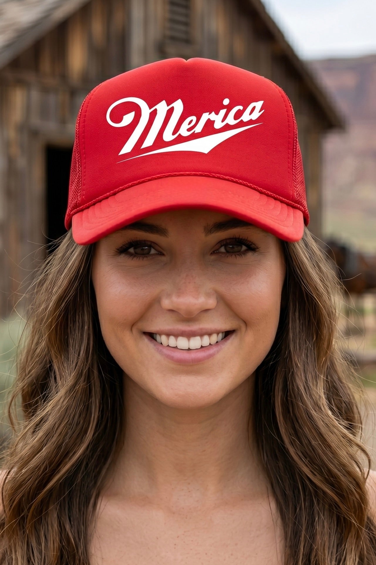 Red America trucker hat with white vintage-inspired graphic lettering, perfect for Fourth of July outfits, country concerts, rodeos, Americana style, and western boutique fashion.