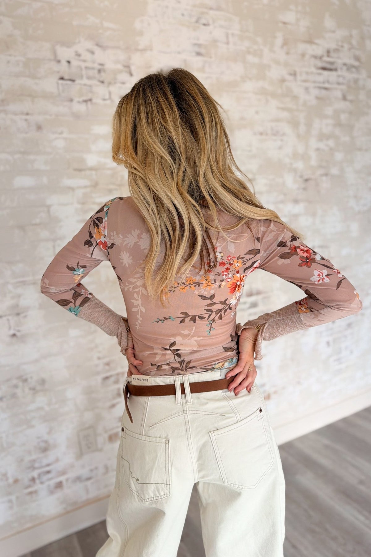 Women’s blush pink floral long sleeve Henley top featuring an all-over vintage botanical print, fitted silhouette, scoop neckline with button placket, contrast textured cuffs and soft feminine styling. A romantic boho-inspired floral top for casual outfits, western styling, layering and transitional fall-to-spring wear.