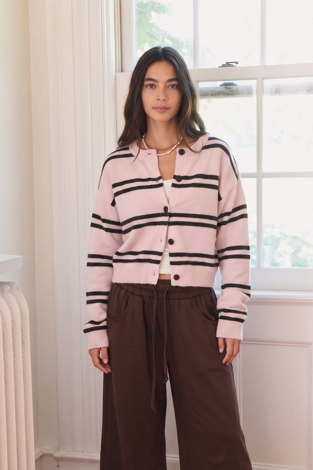 Striped button up knit cardigan in pink and brown stripe and brown and white stripe.