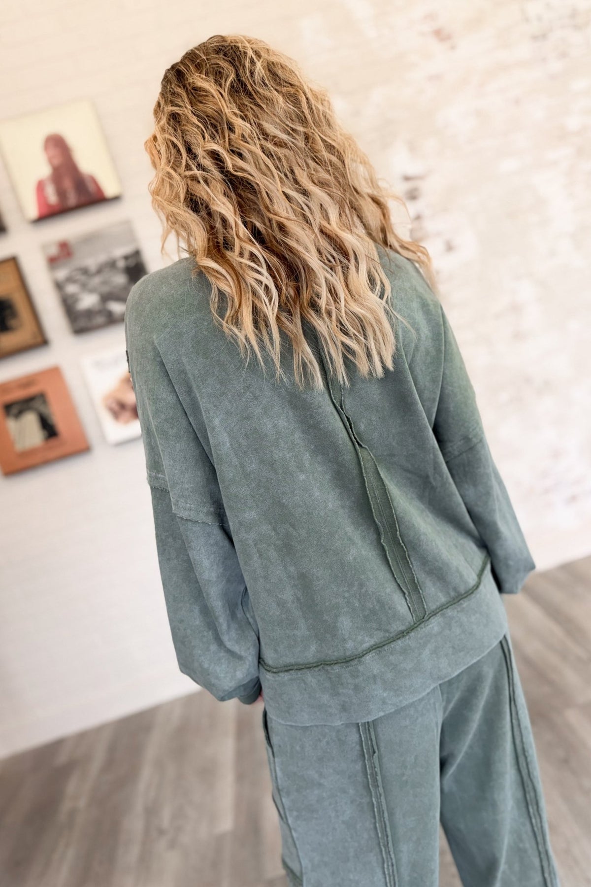 Women’s sage green mineral-washed two-piece lounge set featuring an oversized slightly cropped crewneck sweatshirt with exposed seam detailing and matching relaxed balloon jogger pants with an elastic drawstring waist, oversized patch pockets, exposed seams, and gathered ankles.