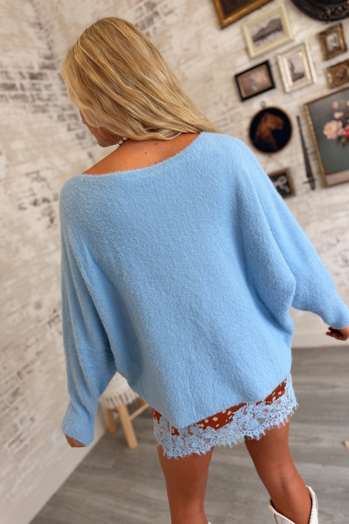 Women’s baby blue fuzzy knit oversized sweater featuring a soft plush texture, wide scoop neckline, relaxed slouchy silhouette, dropped shoulders, and long sleeves for a cozy feminine pullover style.