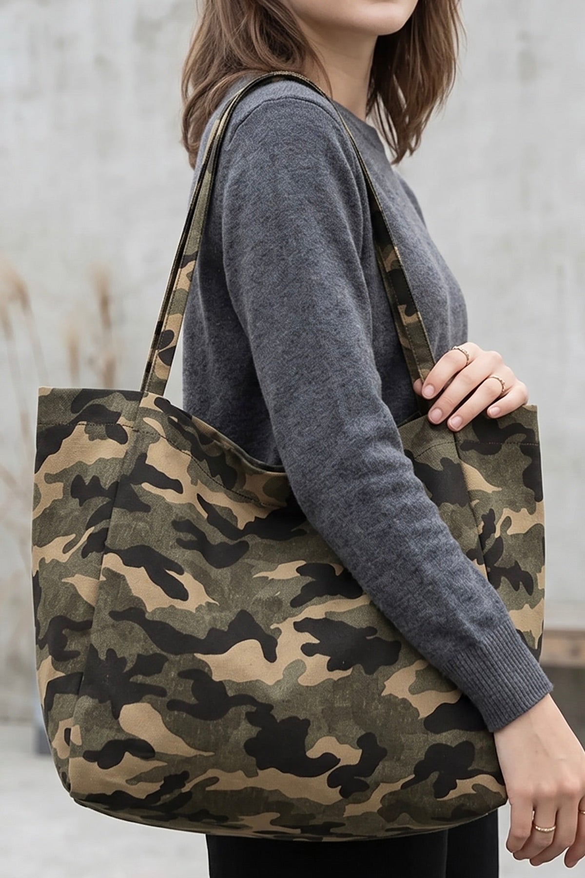 Casual camouflage canvas shoulder tote bag with long straps and oversized slouchy silhouette.
