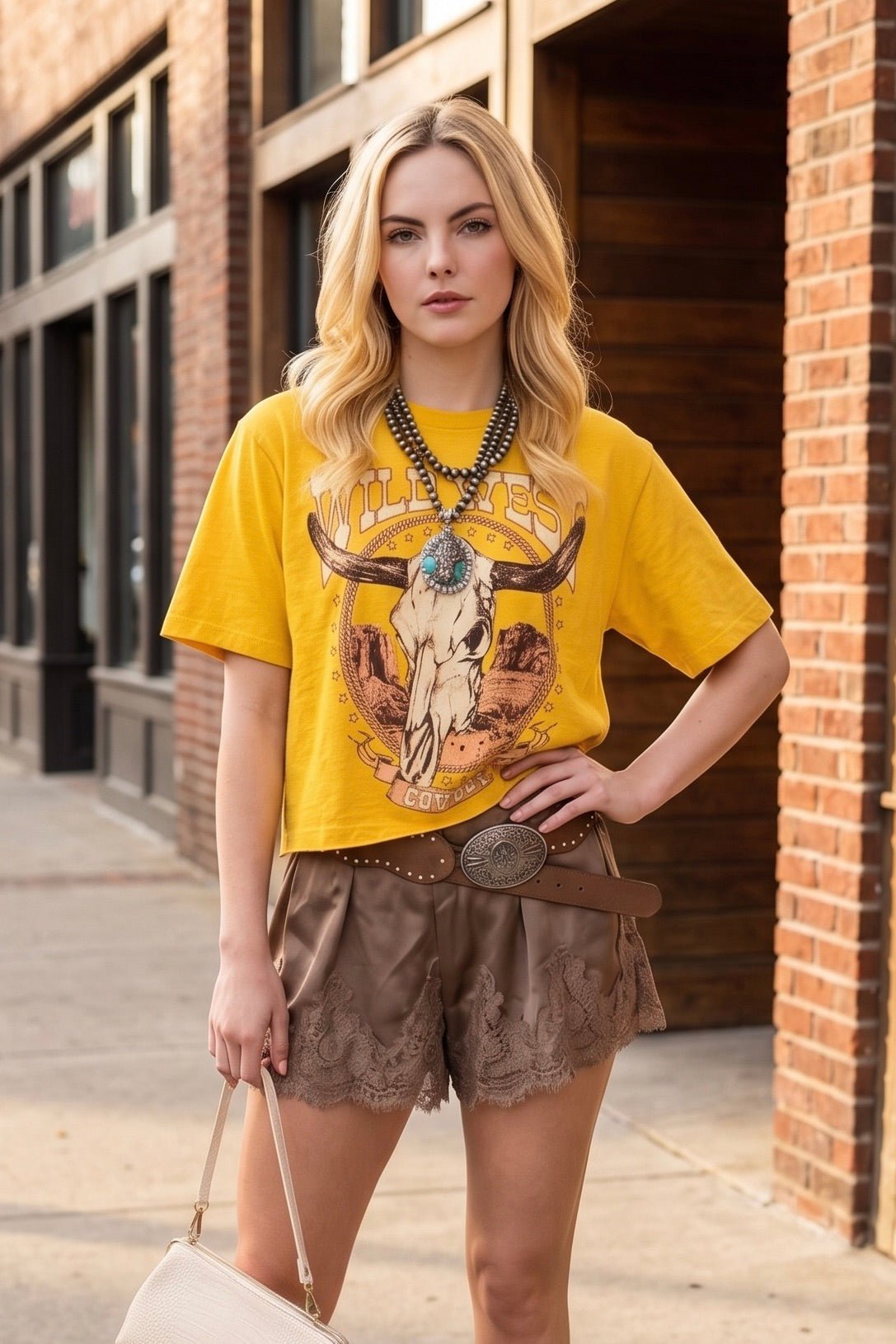 Wild west comboys graphic tee. Mustard yellow with a long horn skull on the graphic. Country concerts, rodeos, festivals

