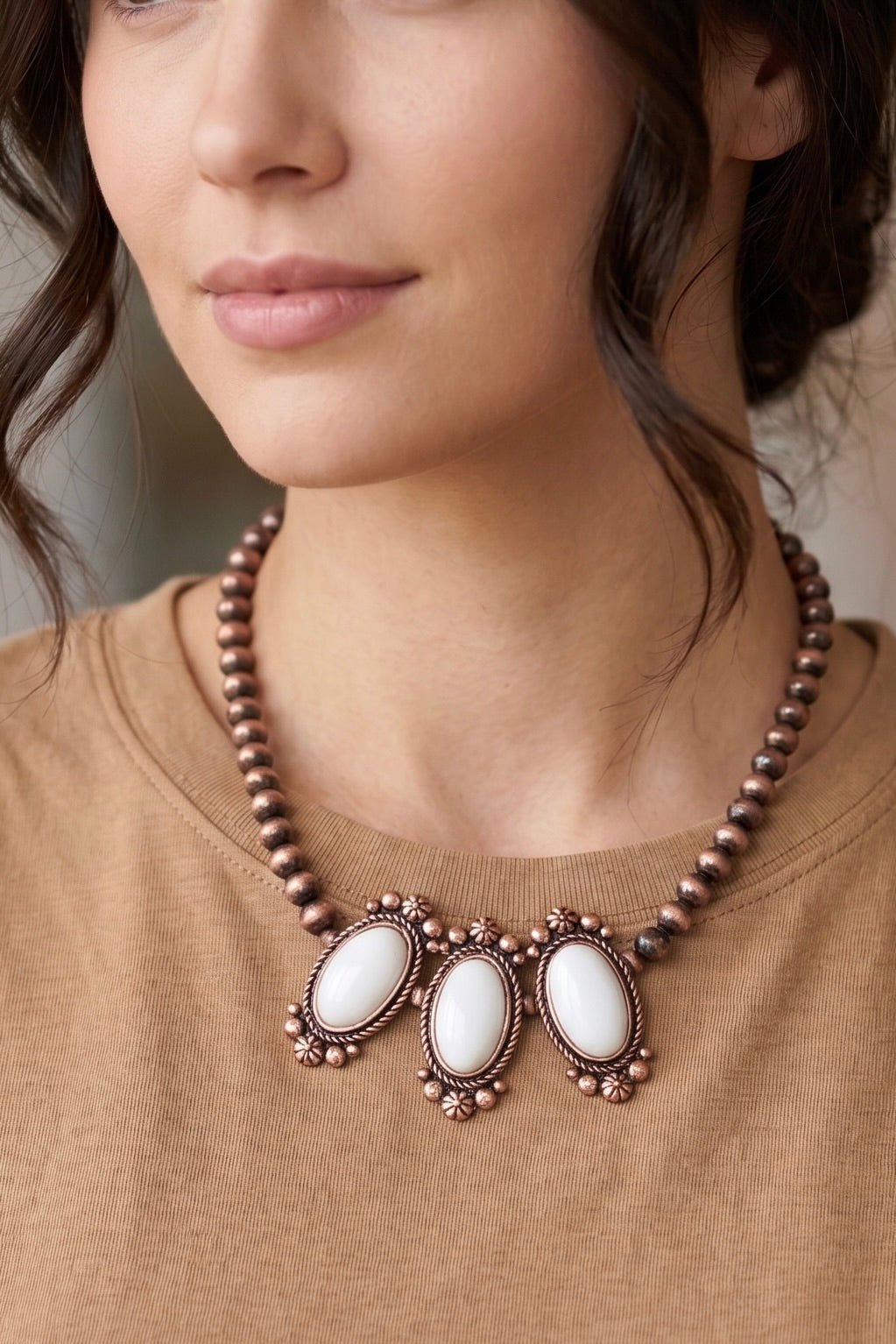 Handmade antique copper-tone Western bead necklace with three oval natural white turquoise stone pendants and floral detailing.