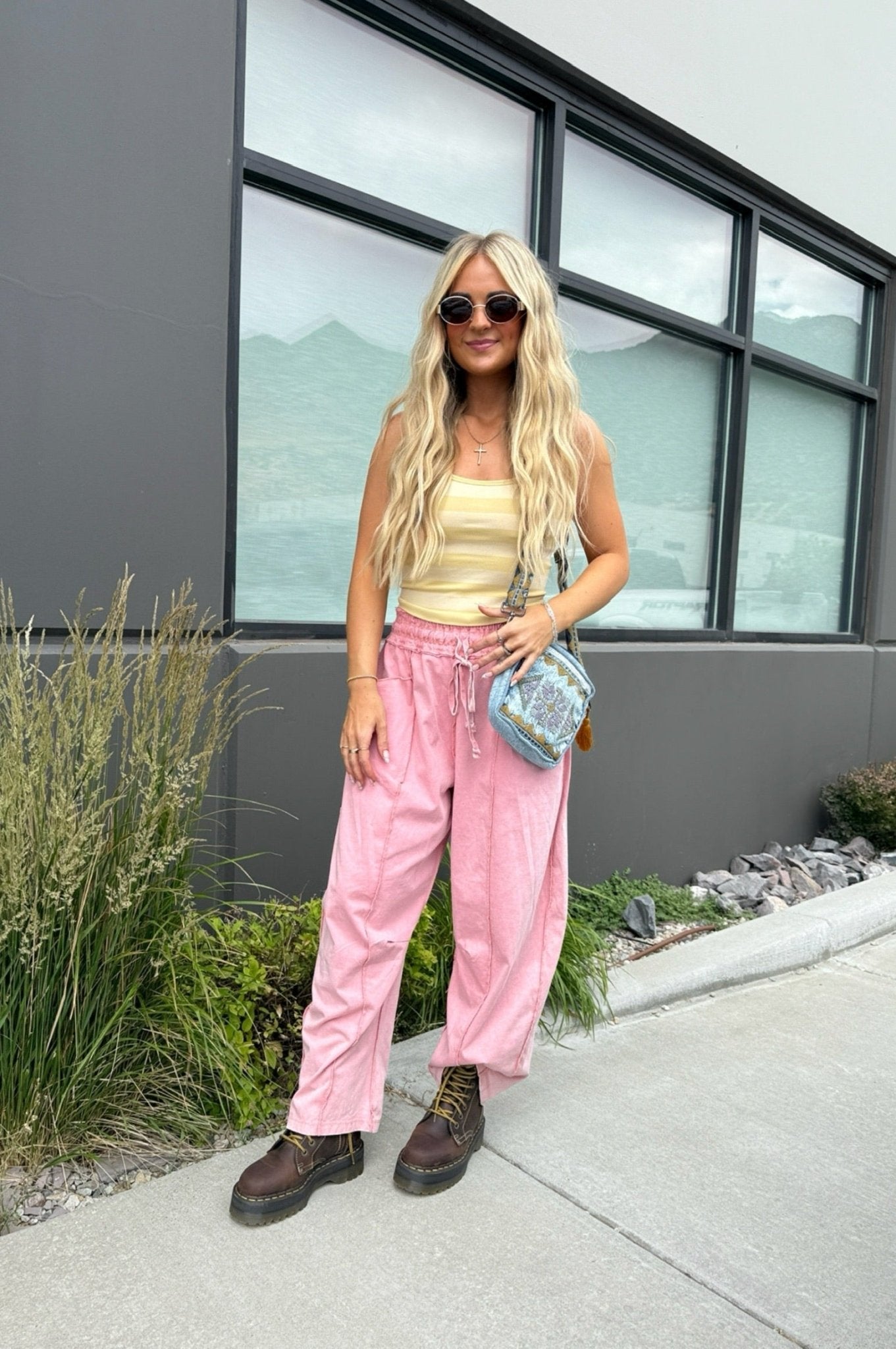 Butter yellow striped fitted tank top with wide straps and a scoop neckline styled with pink lounge pants for a casual summer outfit.
