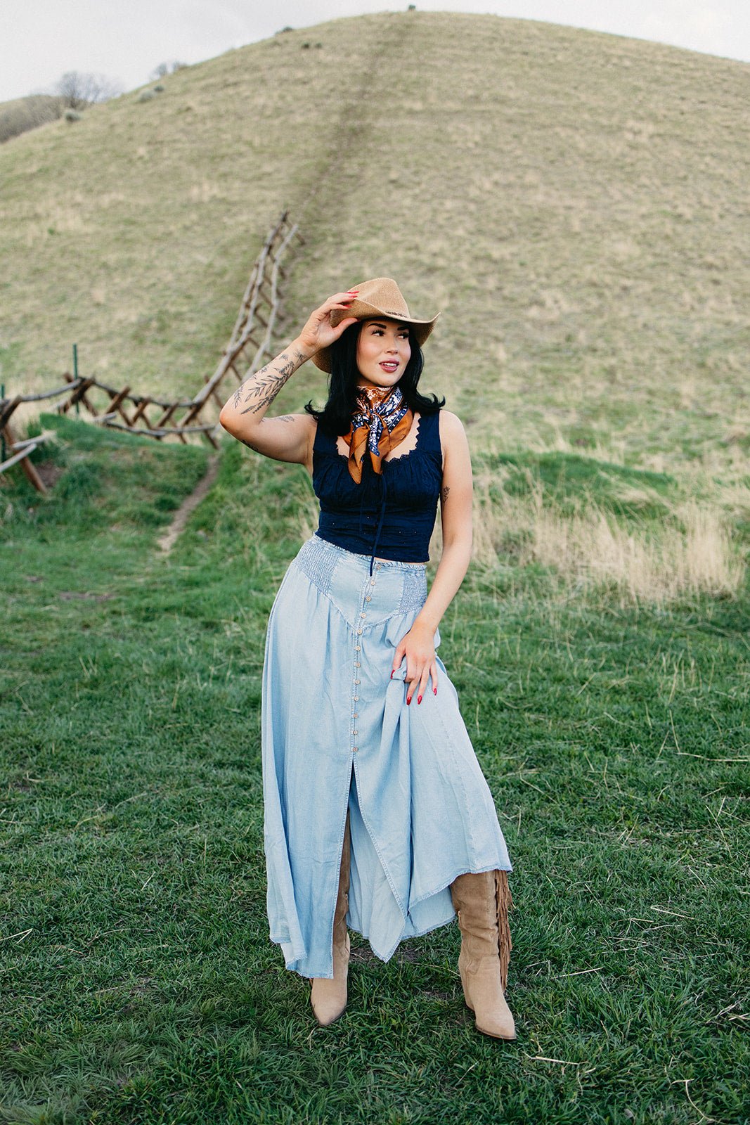 Boho western maxi skirt styled for country concert outfits, western festival fashion, boho cowgirl looks and modern rodeo style from Sand + Charcoal Boutique.