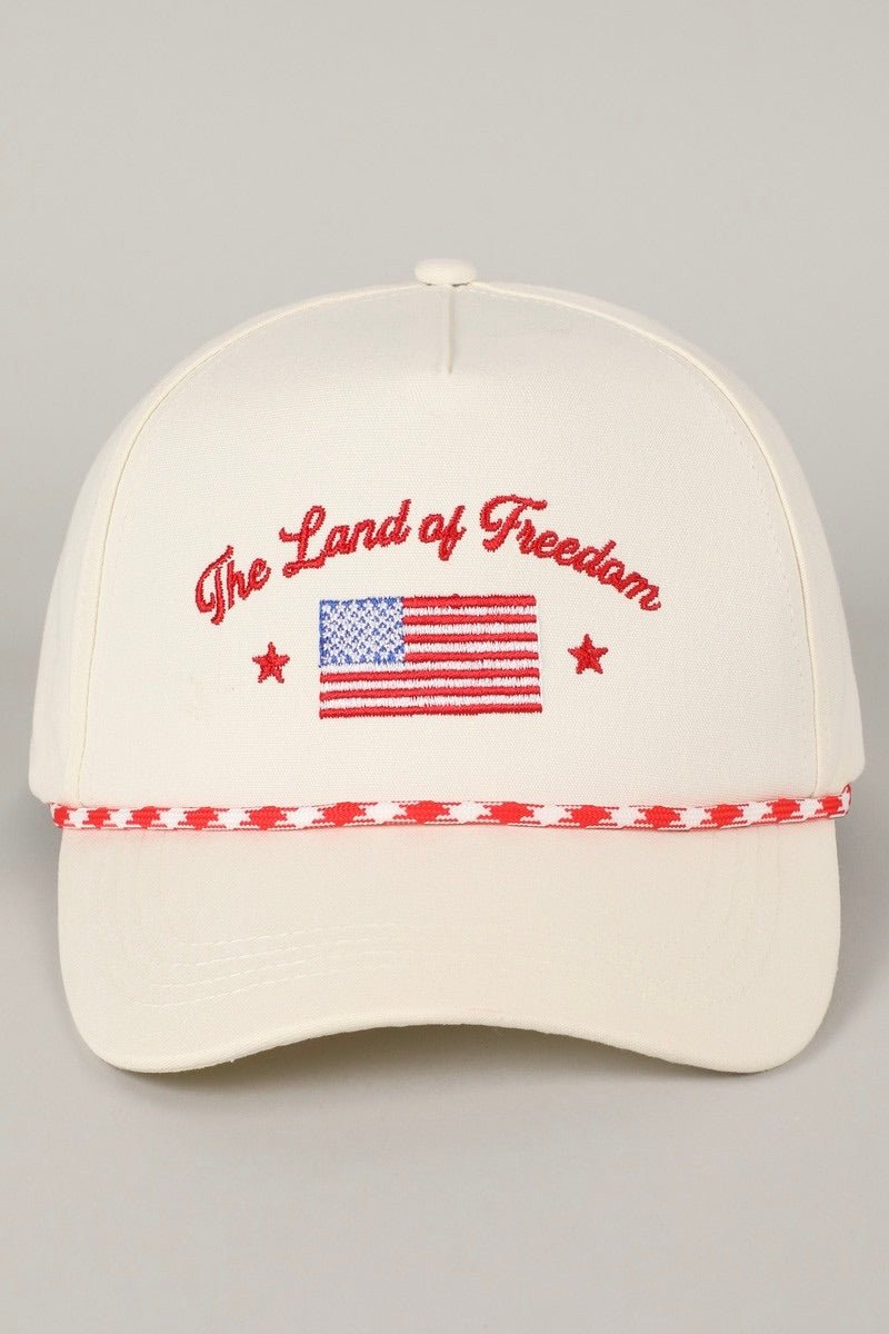 baseball cap with "the land of freedom" graphic text and american flag