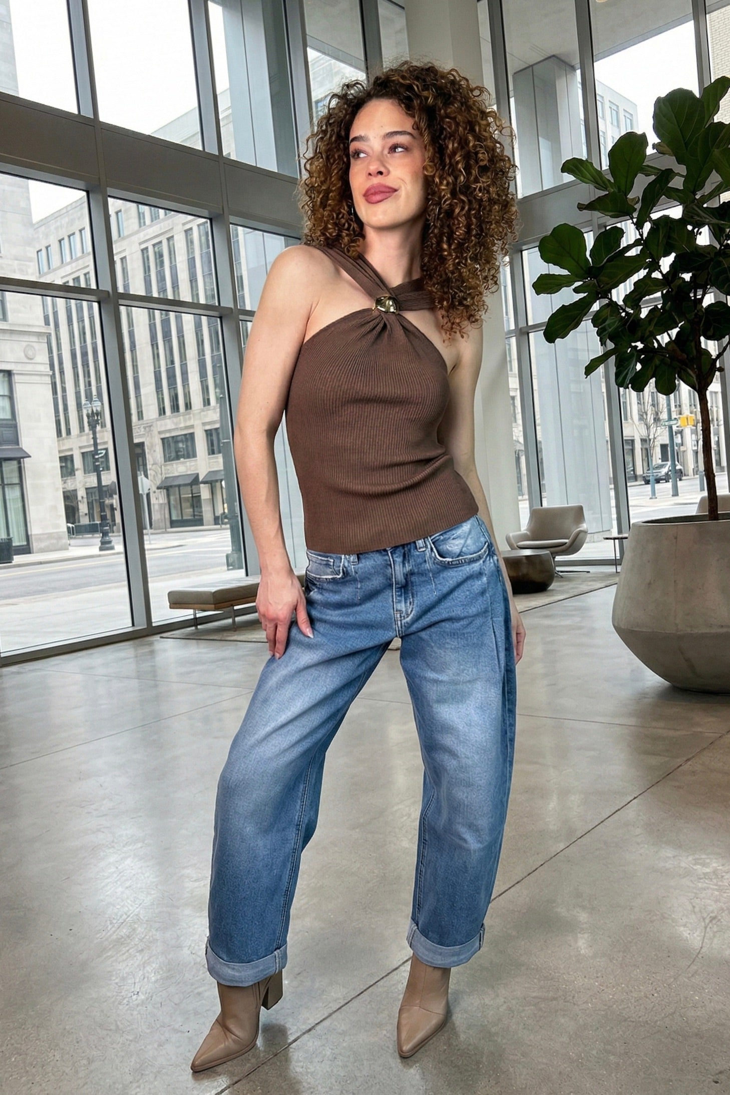Brown ribbed halter knit top styled with relaxed denim and boots for trendy summer outfits, western city fashion, Nashville outfits, casual date night looks, country concert style, and elevated boutique fashion from Sand + Charcoal Boutique.